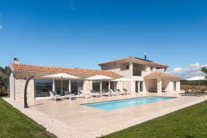 a villa with a swimming pool and a house at Villa Juki by Briskva in Kaštel