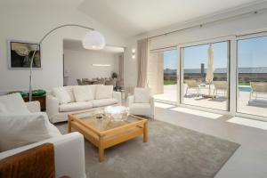 a living room with white couches and a table at Villa Juki by Briskva in Kaštel +32 photos