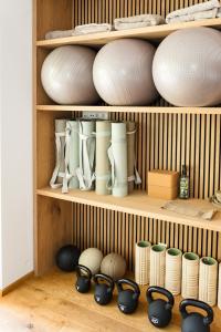a shelf filled with white bowls and other dishes at Boutique Aparthotel Chalets Coburg in Schladming
