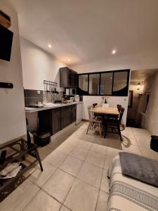 a kitchen and dining room with a table in it at Gîte et chevaux in Sablonnières