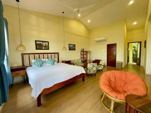 a bedroom with a bed and a living room at Haven Boutique Hotel Quy Nhon in Quy Nhon