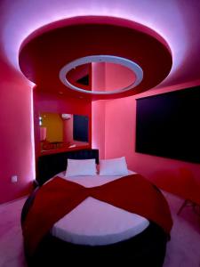 a bedroom with a large bed with a pink ceiling at Agha Motel in Canela