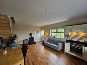 a large living room with a couch and a stove at lakeview Guesthouse Virginia in Lisgrea
