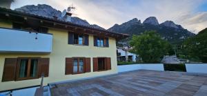 a view of a house with mountains in the background at Residenza Ariete Vista Paganella in Terlago