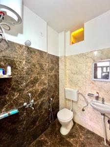 a bathroom with a toilet and a sink at Your second home in Jaipur