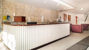 a lobby with a white counter and a bar at Hotel Portobelo Convention Center in San Andrés