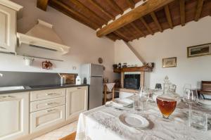 a kitchen with a table with wine glasses on it at A casa di Irma e Nilo in Palaia