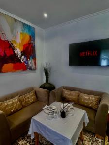 a living room with a couch and a table at Prince Privé Suite in Goranxi