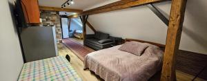 a bedroom with a bed and a couch in a room at Planinski Dom na Travni Gori in Sodražica