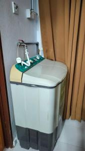 a toilet with a sewing machine on top of it at Liza Homestay in Bachok