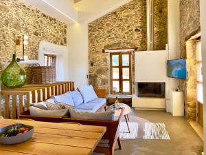 a living room with a couch and a table at The Stone House - Two Bedrooms Maisonette in Avdhoulianá