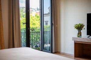 a bedroom with a door open to a balcony at Crisol - Frente a la Parroquia de San Miguel Arcángel in San Miguel de Allende