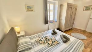 a bed with two pillows on it in a bedroom at Le Nid près de la Saône in Montmerle Sur Saône