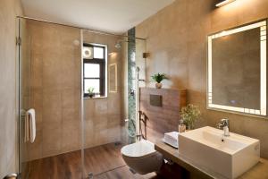 a bathroom with a sink and a toilet and a shower at Greenfield · 3BHK Portuguese Villa in Assagao Goa in Goa +17 photos