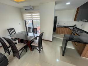 a kitchen and dining room with a table and chairs at Two-bedroom apartment in Santa Cruz de la Sierra