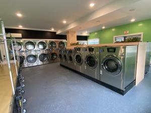 a row of washing machines in a laundry room at The Whitetail Inn and Suites- Lincoln in Lincoln