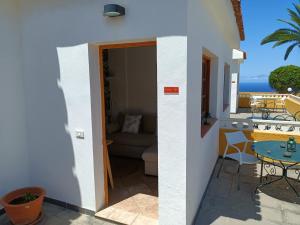 a room with a balcony with a couch and a table at Tenerife Paradise 06 Room King - Hotel Rural Fsj in San Juan de la Rambla