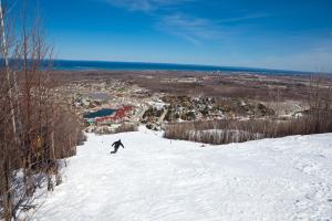 a person riding a snowboard down a snow covered slope at Cachet Crossing by Property Valet in Blue Mountains