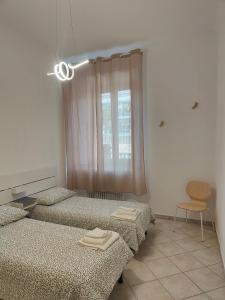 a room with two beds and a window at Appartamento in Pietrasanta in Pietrasanta