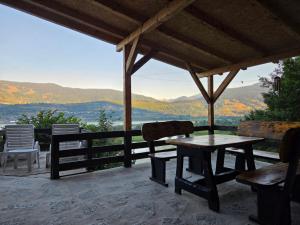 a table and chairs on a porch with a view at Visitor place 2 in Plav