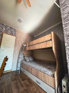 a bunk bed in a room with a staircase at Stan na dan studio in Inđija +10 photos
