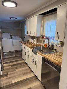 a kitchen with white cabinets and a sink at Charming 3-bedroom house in Traverse City