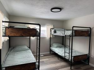 a room with three bunk beds and a window at Charming 3-bedroom house in Traverse City