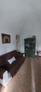 a living room with a couch and a green cabinet at Ca du Len Gorra - MTB's Friendly in Finale Ligure