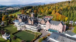an aerial view of a large castle with trees at Crieff Hydro in Crieff