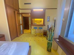 a room with a bed and a vase with flowers in it at Appartme Nuova 52 in Milan