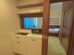 a small room with a kitchen and a bedroom at Appartme Nuova 52 in Milan +9 photos