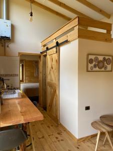 a kitchen with a sliding door in a room at Mini Casa a 6 kilómetros de Villa Cerro Castillo Aysen Carretera Austral in Villa Cerro Castillo