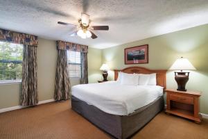 a bedroom with a bed and a ceiling fan at Mountain Meadows in Pigeon Forge +23 photos