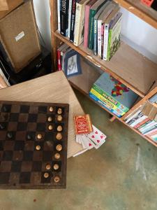 a chess board on a table next to a book shelf at Badili Farmstay in Thika