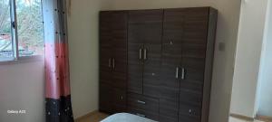 a brown cabinet in a room with a window at Duplex Los Araujos in Yerba Buena +3 photos