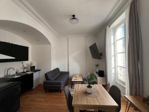 a living room with a table and a couch at The Central - 5p - Rêve au Mans in Écommoy