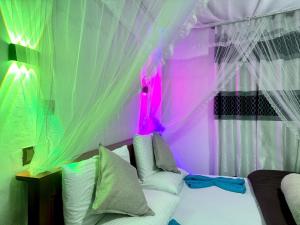 a bedroom with a bed with a canopy and a couch at Ella Serene Stay in Ella