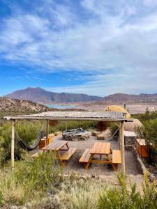 a picnic table in the desert with mountains in the background at El Nido Domos in Mendoza