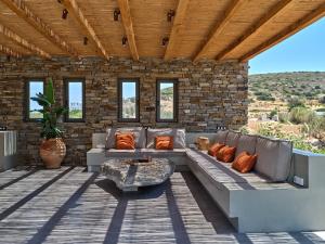 a patio with a couch and a table at Villa Zamira in Isterni