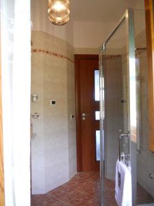 a bathroom with a shower with a glass door at LA CASA di ROSA 