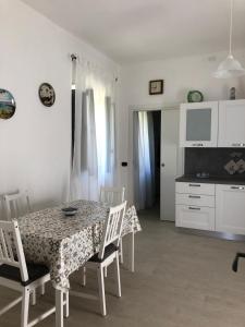 a kitchen and dining room with a table and chairs at Da Cumma' Franca in Maratea +11 photos