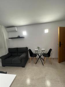a living room with a couch and a table and chairs at Residencial Alcoy in Alcoy +83 photos