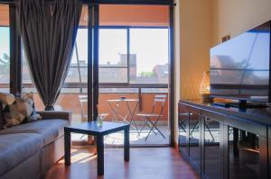 a living room with a couch and a flat screen tv at Home & Pet - Tralci in Basiglio +4 photos