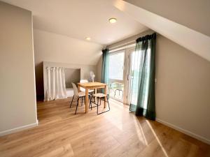 a dining room with a table and a window at Lejnieki Apartment 4 in Pape