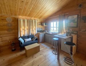a living room with a blue couch and a table at Chalet Boréal in Pujaudran
