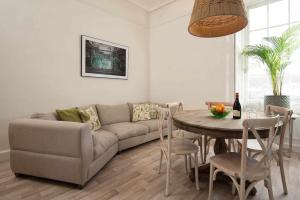 a living room with a couch and a table at Stylish Town Apt in Hawick +15 photos