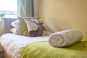 a bedroom with a bed with a deer pillow on it at Merriotts Court - Parking - WIFI in Newport