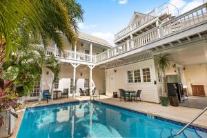 a swimming pool in front of a house at FUENTE at Azul Mansion Key West in Key West