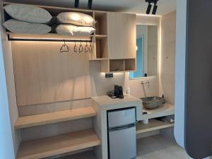 a small bathroom with a sink and a mirror at Thrive in Sarti +167 photos