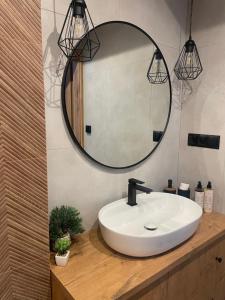 a bathroom with a white sink and a mirror at Ciwersówka Domki Białka Tatrzańska in Białka Tatrzańska +40 photos